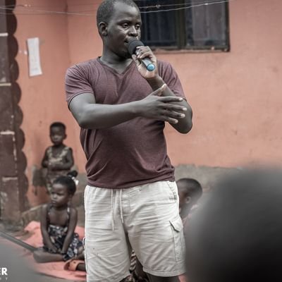 African artist teaching orphan children in Uganda art skills in paintings, wood carving ,jewelry, and others.