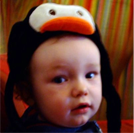 I'm not a cute toddler with a penguin on my head, honest.