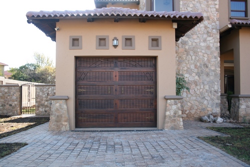 Uniquely carved Meranti Garage doors and Exterior doors. Our products also include the Standard ranges. We also service and do repairs as well as automation.