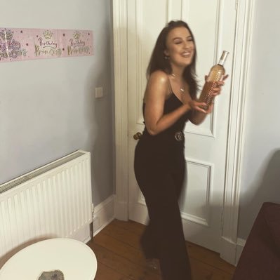 A bold brunette doing bold brunette things. Drinking or crying or doing both at the same time. She/her