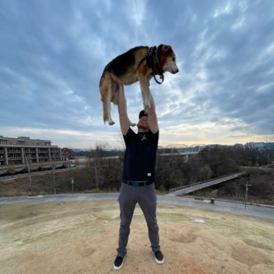 Just a man with his dog and cat.