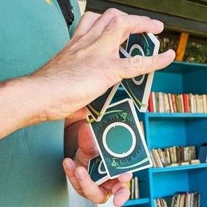 Magician! Or, card magician? Sleight of hand practitioner, with cards? Hobbyist, maybe? Cardist? No, no cardistry. Just magic. With cards.