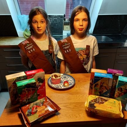 We are two twins in Girl Scouts getting to sell cookies for the first time.  We are overseas because our Dad is in the military, unable to sell door to door.