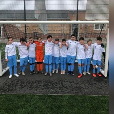 A group of young lads enjoying and learning the game.