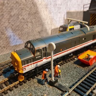 2 🏳️🌈🏳️🌈 train drivers and a model railway. A OO gauge layout loosely based on a fictional 1990 (ish) northern town. A work in progress.