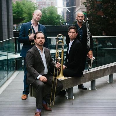 We are a unique chamber ensemble featuring baritone Tyler Bouque, trombonist William Lang  trumpeter Andrew Kozar, and bass clarinetist Adrian Sandi