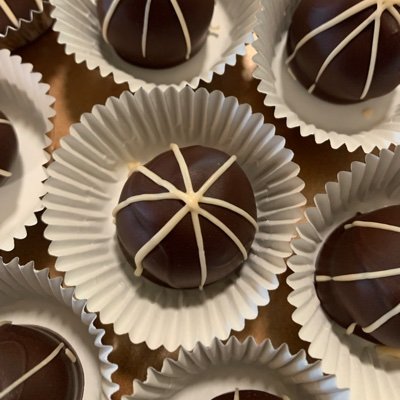 We at 80 Days Cafe make hand-rolled & hand-dipped artisanal chocolate truffles and caramels using the finest chocolate and our favorite alcohol flavors.