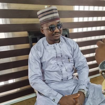 Born in the Hausa lower Class. public servant and A comrade.