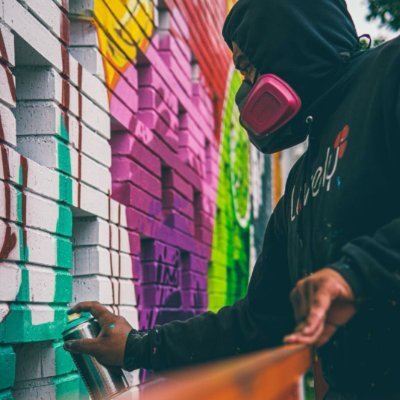 Local Muralist creating vibrant images to uplift the community.