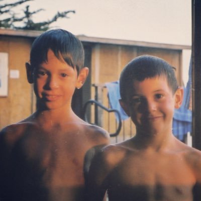 Two brothers writing songs and singing them.