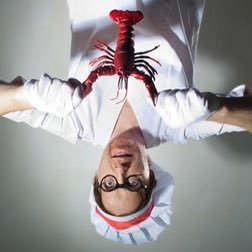 chef holding a lobster (upside down)