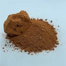 Maroon coloured, fine, dry powder consisting of tiny particles from a small rectangular block typically made of fired or sundried clay, used in building.