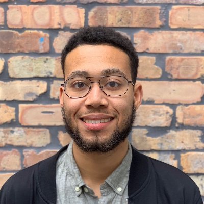 sidneywijn's profile picture. Seated at a standing desk