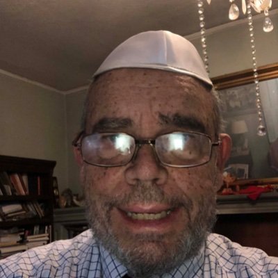 Research mathematician, Christian who practices Judaism and Buddhism, studies Hinduism. The crossed bricks say,