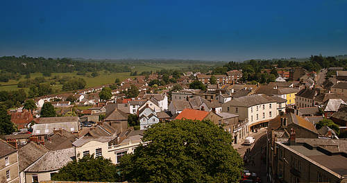 Axminster is a market town and civil parish on the eastern border of Devon in England. The town is built on a hill overlooking the River Axe