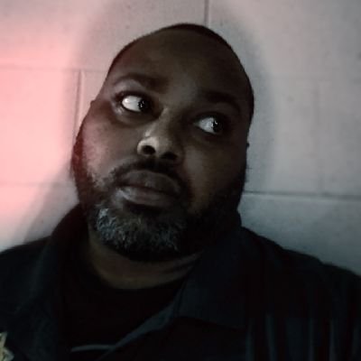 A simple black male human being, whose wide sense of humor keeps him sane in a mad world