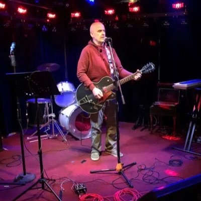Guitar man roaming the open mics, novelist, poet, biographer