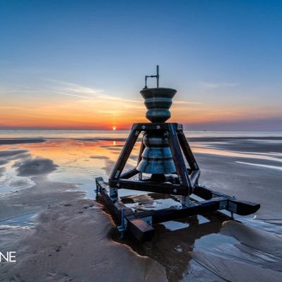 the bell is located on the beach where it can be viewed.