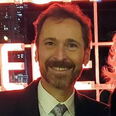 Hippie in a suit advocating for peace, love, and the Oxford comma.