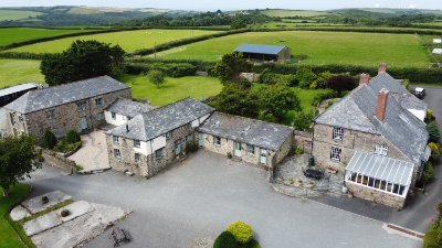 Top-rated farm cottages in a beautiful Cornish valley, close to the beach. 7 cottages & two yurts, a heated swimming pool, games room, feed the animals & more.