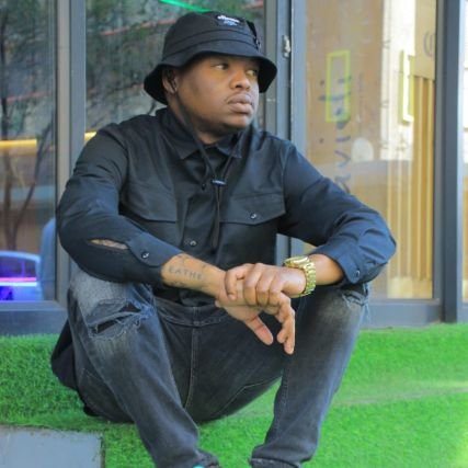 Son of Nomusa| Father & husband, defender of kin | Class-conscious observer of society | Grounded in struggle, committed to justice.