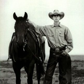 A solitary cowboy riding the range on a wornout saddle. Catholic. American. Texan.