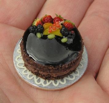 Specialises in her own hand crafted dollshouse miniatures - food, flowers, and miniature knitting.