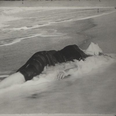 A woman adrift—restless, entangled in the tides of her thoughts, and lost within the ink of her own words