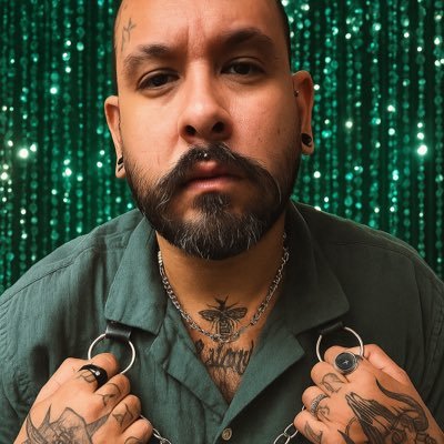 Bear-ish bearded tattooed dude from La Isla del Encanto.