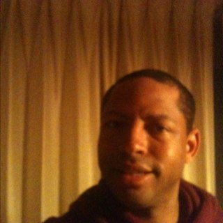 Black male, light to medium golden brown complection with brown eyes and black hair and two tattoos, approximately 5'7 give or take.