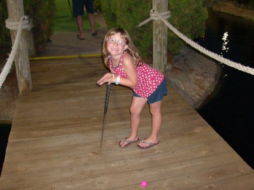 at mini golf, posining for the camera