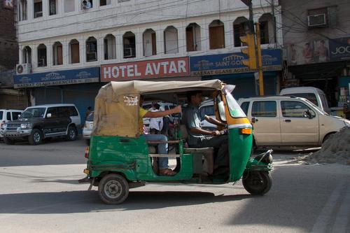 Two software engineers driving across India for charity in a motorized rickshaw.
