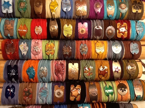 A Wrap On The Wrist  bracelets are colorful, one of a kind accessories, combining the finest hand dyed silk ribbons with a combination of enameling, painting,