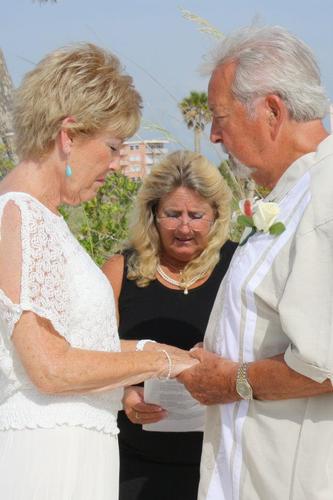 Officiant, Minister,  Coordinator, Planner,  Paralegal.  Smile and everyone will smile with you!