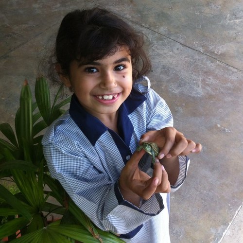 my cute little daughter Emaan Touseef playing with her pet turtle