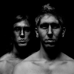Two quiet men conjuring dark metallic hymns.