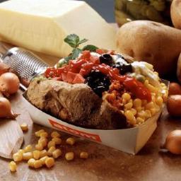 Kumpir is simply a unique way of serving baked potatoes. It consists of a baked potato mixed with butter, cheese and choice of several delicious toppings.