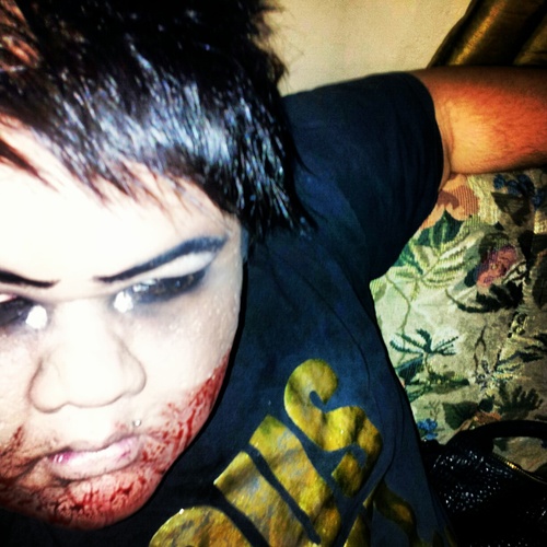 NIKNASTY's profile picture. Dressed in all black with the gat in the lap