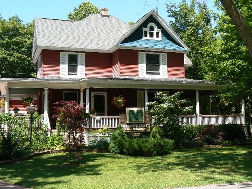 Surrounded by woods, this beautiful Victorian-style home offers quiet relaxation in an ideal setting.