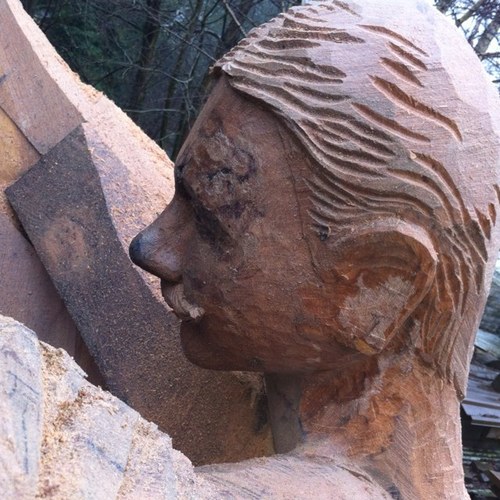 sculptor working on large scale public realm using fallen oak north wales