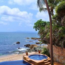 Privately gated 10,000 sqft 6 bedroom beachfront villa rental featuring a full staff for all guests. Indulge in luxury travel in Mexico as your family vacation.