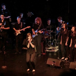 Community-based music program for young people that teaches musical skills through the performance of popular music.