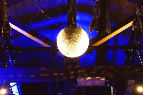 Up a ladder, pointing lights at puppets