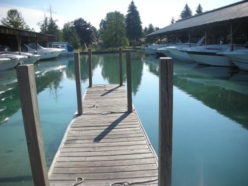 Torch River Marina located on Torch Lake, MI.  Covered boat slips, boat storage, boat rentals, boat sales and marine services. 231-322-4495