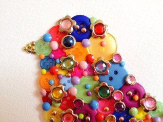 I make and sell pictures from buttons and sparkly things, when my house is quiet enough to concentrate!