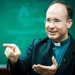 Sacerdote, Teologo, Professore di Teologia Morale, DIrettore del Centro di Ricerca Markets, Culture and Ethics della Pontificia Università della Santa Croce