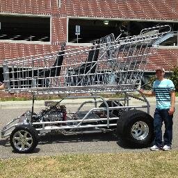 A STREET-LEGAL, ten-foot tall SHOPPING CART powered by a Chevy V-8 engine. Big, loud, fun - and it seats six! Contact us to book your event.