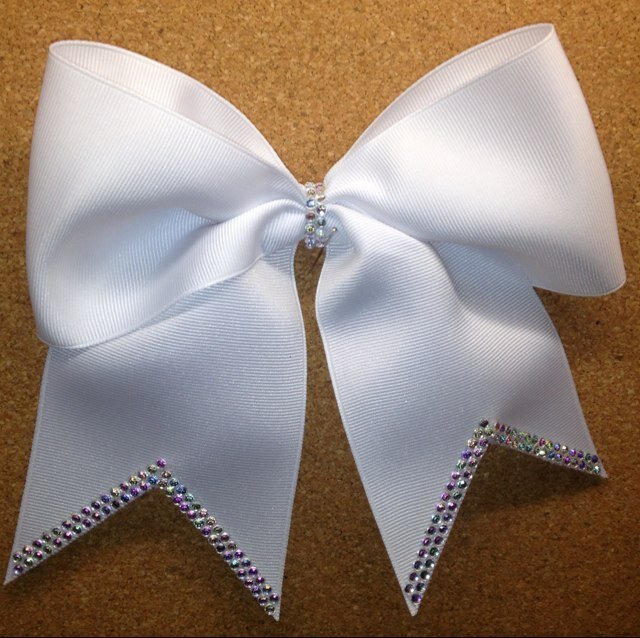 3 inch custom made, competition worthy cheer bows. The small bows make fun little sis bows. I love adding sparkle and shine to my bows. Find me on Facebook too.