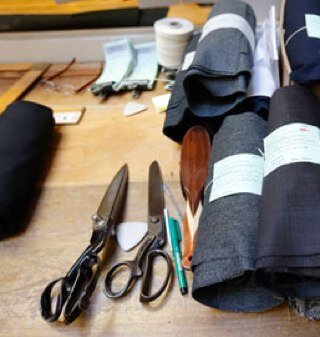 Exclusivity.  Labels say you're one of the boys, but a Bespoke suit says you are the Man.  A product made for a market of just One.