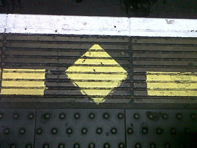 I am the Manor House Diamond, a yellow symbol on the floor on the northbound Piccadilly line at Finsbury Park. I show residents of Manor House where to stand.
